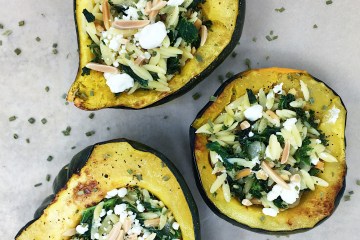 stuffed acorn squash with kale orzo almonds and goat cheese